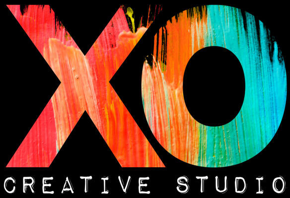 XO Creative Studio Logo Logo for Xan's company, XO Creative Studio. The letters X and O appear in painted streaks of coral, orange, and teal. Below that, the words "Creative Studio" appear in small white text, using a font that looks printed or pressed, like a typewriter or a lab